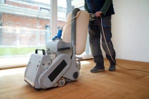 sanding,hardwood,floor,with,the,grinding,machine.,repair,in,the