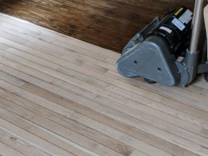 Sanding floor with large sanding machine.